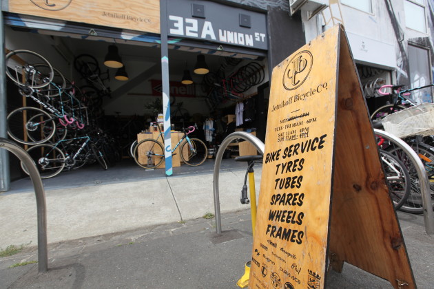 A pump for free air next to their sandwich board sign gives passing cyclists a reason to stop.